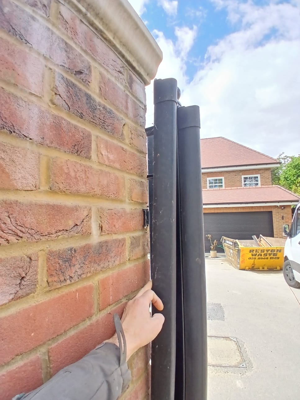 Cable conduits running down a brick wall, not fixed in place